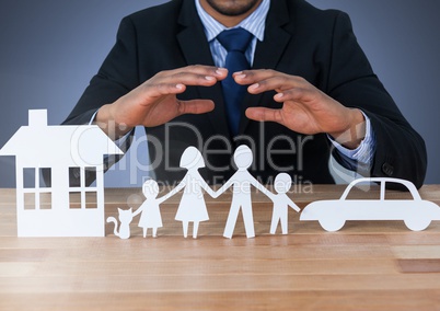 Cut out house family and car under protective hands