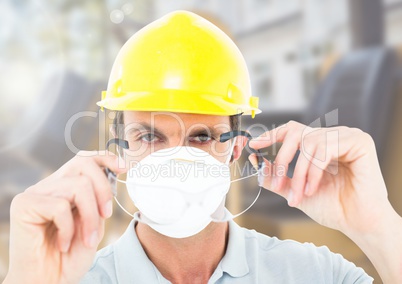 Construction Worker with mask in front of construction site