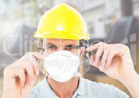 Construction Worker with mask in front of construction site