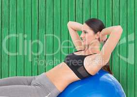 fitness woman with big ball with green wood background