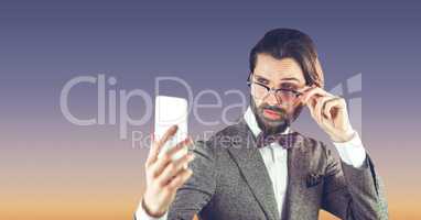 Hipster man with glasses taking a selfie on blue background