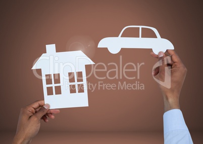 Cut out house and car in hands