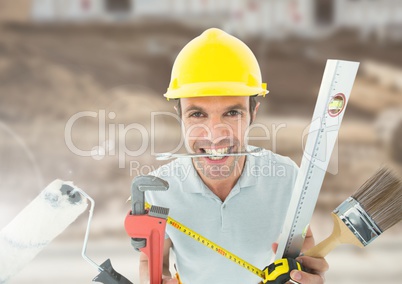 Construction Worker with tools in front of construction site