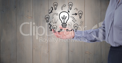 Business woman mid section with lightbulb doodles and flare against grey wood panel