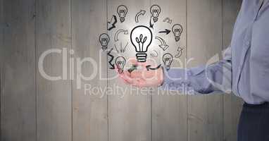 Business woman mid section with lightbulb doodles and flare against grey wood panel