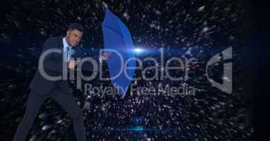 Digital composite image of businessman holding blue umbrella amidst asteroids