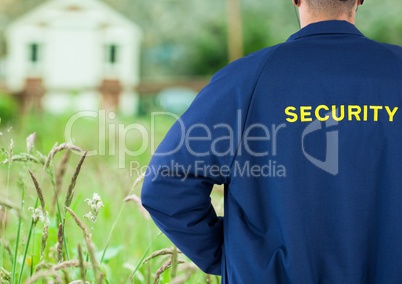 Rear view of security guard standing on field