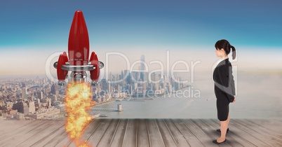Digital composite image of businesswoman standing on pier and watching rocket launch against city