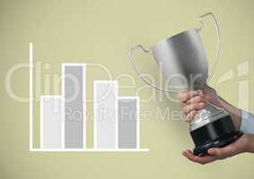 Cropped image of hand holding trophy by graph against beige background