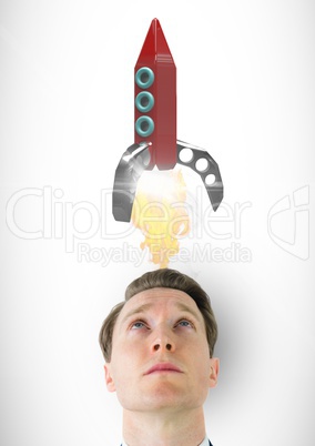 Digital composite image of man looking at rocket launch over head against white background