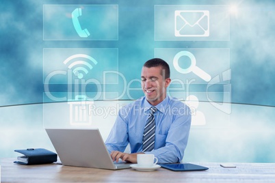 Businessman working on his computer in front of digital board