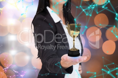 Businesswoman holding a trophy