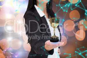 Businesswoman holding a trophy