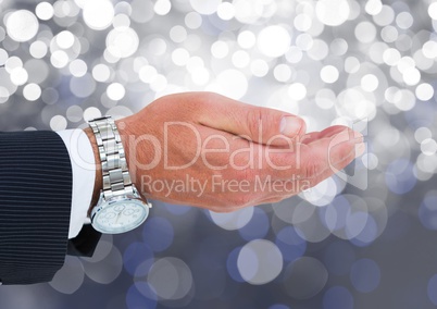 Hand open with rich watch with sparkling light bokeh background