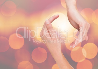 Hands curved posture with sparkling light bokeh background