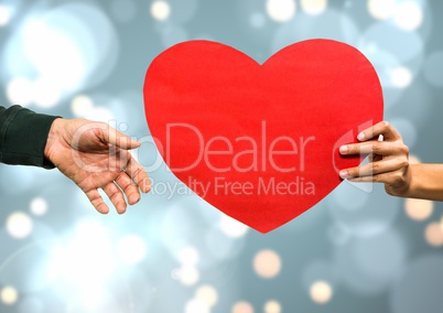 Hands holding heart with sparkling light bokeh background