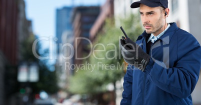 Security guard with walkie talkie against blurry street