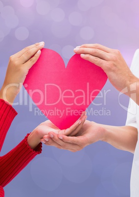 Hands holding heart with sparkling light bokeh background