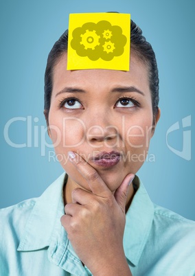 Woman thinking with yellow sticky note on head showing cloud and gear graphic against blue backgroun