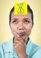 Woman thinking with yellow sticky note on head showing blue moneybag doodle against yellow backgroun