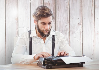 Hipster man  on typewriter with wood