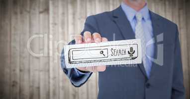 Business man mid section with card showing brown search bar against blurry wood panel