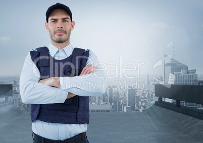 Security man arms folded in front of city