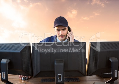Security man on computers with cloudy sky