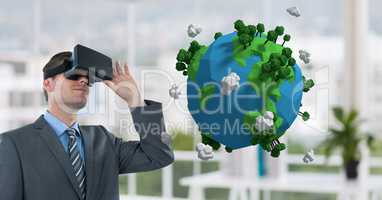 Businessman watching 3D earth with virtual glasses