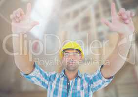 Construction Worker with hands up in air in front of construction site