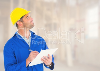 Construction Worker with pen chart in front of construction site