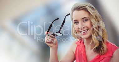 Happy blond-hair woman holding her glasses in hands
