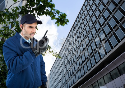 Security guard holding walkie talkie standing in city