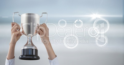 Digital composite image of business hand holding trophy