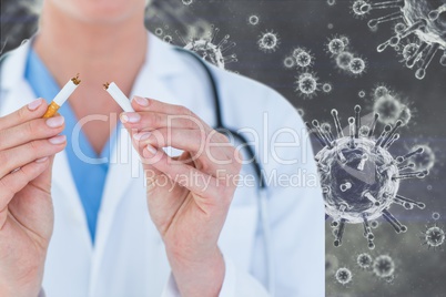 Doctor destroying a cigarette against virus background