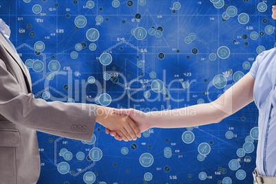 Handshake between a businessman and a businesswoman against icons background