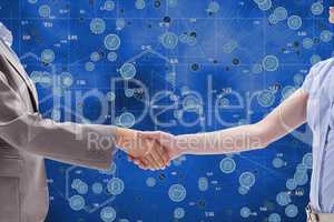 Handshake between a businessman and a businesswoman against icons background