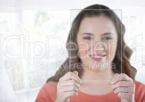 Woman holding glass screen by bright sunny window
