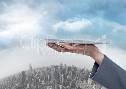 Businesswoman holding tablet over round city