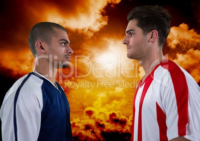 Soccer players looking each other with orange sky background
