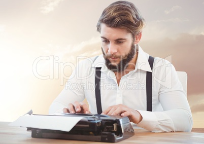Hipster man  on typewriter with sunset
