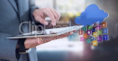 Businessman holding tablet in office with apps