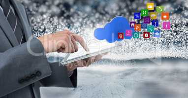 Businessman holding tablet with apps and snow backgorund