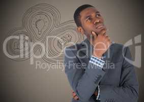 Business man thinking against brown background with business doodle