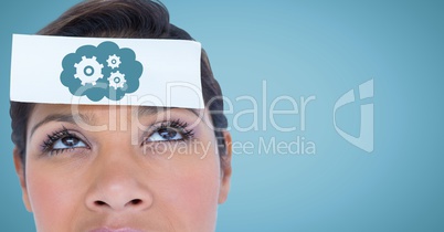 Close up of woman with card on head showing blue cloud and gear graphic against blue background