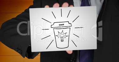 Business man mid section with card showing coffee doodle against orange wood panel