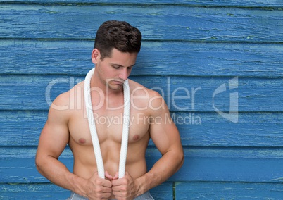 young fitness man with blue wood background