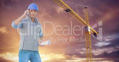 Labourer calling someone close to a crane with purple sky