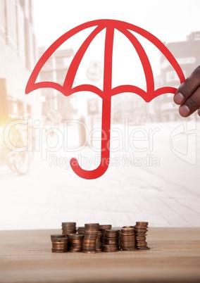 Cut out umbrella over money coins