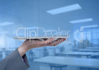 Businesswoman holding tablet in blue workshop factory
